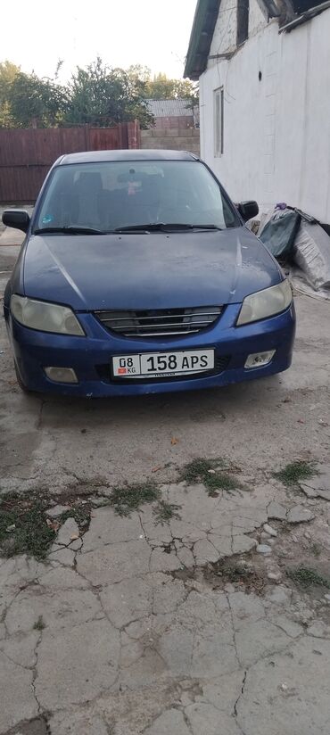 чехол для машины цена: Mazda 323: 2003 г., Бензин, Хэтчбэк