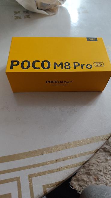 POCO M8 Pro 5G — смартфон с поддержкой 5G в фирменной жёлтой коробке — 2