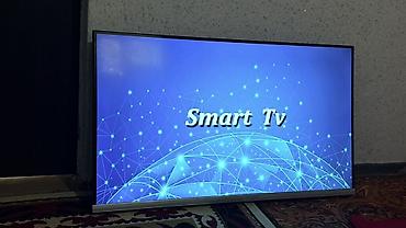 Телевизоры: Телевизор Smart TV, диагональ около 40–43". Тонкие рамки, нижняя — 2
