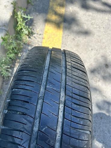 185 65 14 type 0: Michelin markalı avtomobil şini. Ölçüsü: **185/70 R14** Yük/sürət — 1