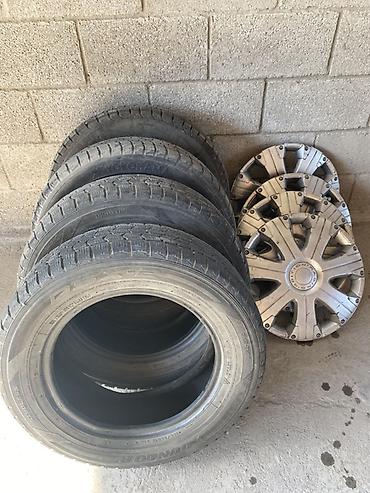 Комплект: 4 зимние шины Dunlop и 4 колпака. Характеристики шин: -