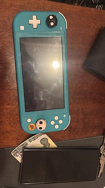 nintendo switch 3 lite: Nintendo switch lite üzerinde cantası. hic bir problemi yoxdu — 1