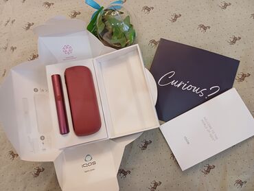 Toy paltarları və aksesuarları: Salam. IQOS ILUMA seriyasından sunset red rəngində cihaz. Sadəcə