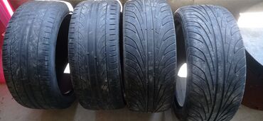унаа тетиктери: Четыре автомобильные шины размером 225/45R17. Они имеют протектор с