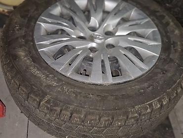 225 35 18: Комплект зимних шин 215/65 R16 на дисках с колпаками Toyota — 1