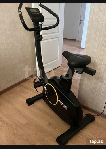 Uzunmüddətli kirayə mənzillər: Qara rəngdə olan, «Marshal Fitness» markalı велотренажер. Üzərində
