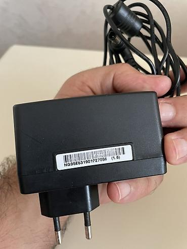modem adapter: LG orijinal “Switching Adapter” enerji bloku LG televizorunun üstündə — 2