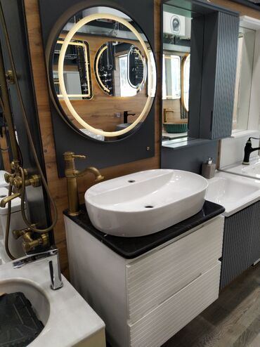 moydadir hamam ucun: Oval formalı, ağ rəngdə, iki dəlikli keramika lavabo. Üzərində qara
