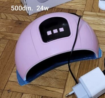 kapi za nokte protiv gljivica: Roze UV lampa za nokte snage 24W. Ima crni panel sa tri dugmeta za