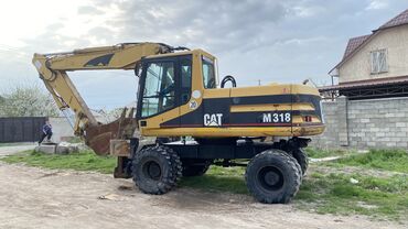 меняю недвижимость: Экскаватор, Caterpillar, 2000 г., Дөңгөлөктүү