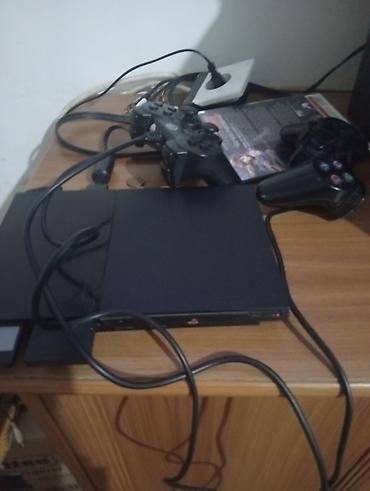 plesdeşin 2: PlayStation 2 Slim oyun konsolu 2 pult kavbellerle beraber 8 disk — 1