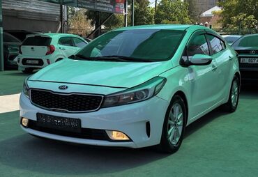 машине арзан: Kia K3 (седан), белый цвет кузова. Ключевые особенности: - Дизайн
