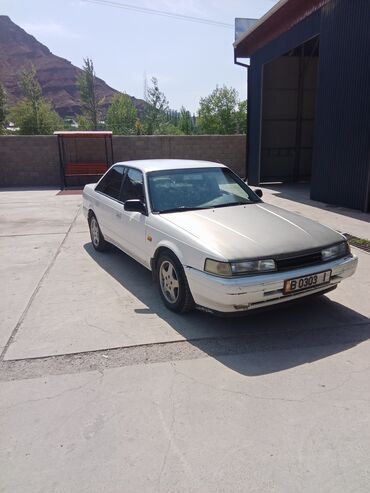 запчасти хонда цивик бишкек: Белый седан Mazda 626 с серым капотом, оснащенный четырехдверным