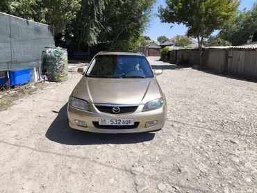 тюнинг мазда 323f слепая: Седан Mazda Familia золотистого цвета, представленный на снимках