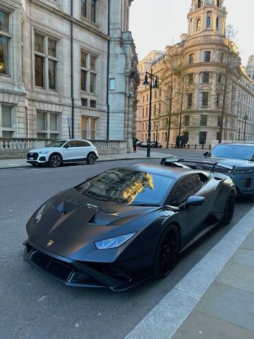 машина ламборгини: Автомобиль Lamborghini Huracán STO с матовым черным покрытием. Оснащен