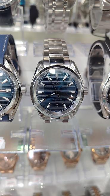 kostuyum: OMEGA kişi qol saatları – Seamaster və Speedmaster kolleksiyaları — 1