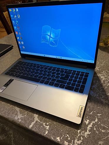 lenovo log: Lenovo noutbuku – gümüşü rəngdə, nazik korpuslu, 15.6" ekranlı model — 3