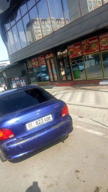 срочно продаю аварийное авто: Автомобиль Hyundai Accent синего цвета с кузовом седан. Модель имеет