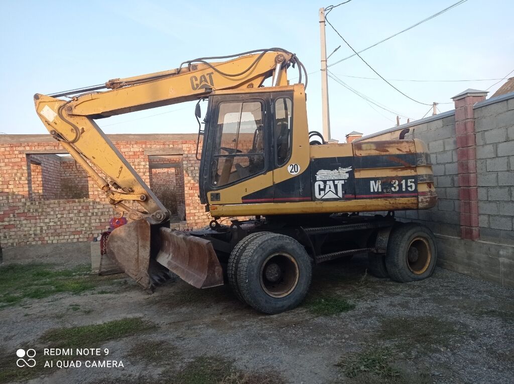 Экскаватор, Caterpillar, 2000 г., Колесный