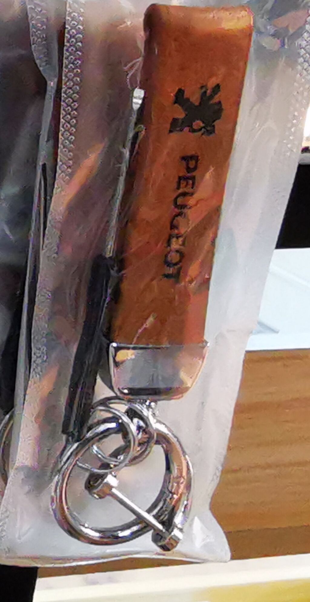 Privesci za ključeve: Privezak za ključeve sa logotipom Peugeot. Izrađen od braon materijala