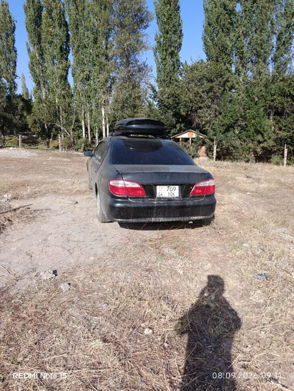Легковой автомобиль седан черного цвета с багажным боксом на крыше: фото 3